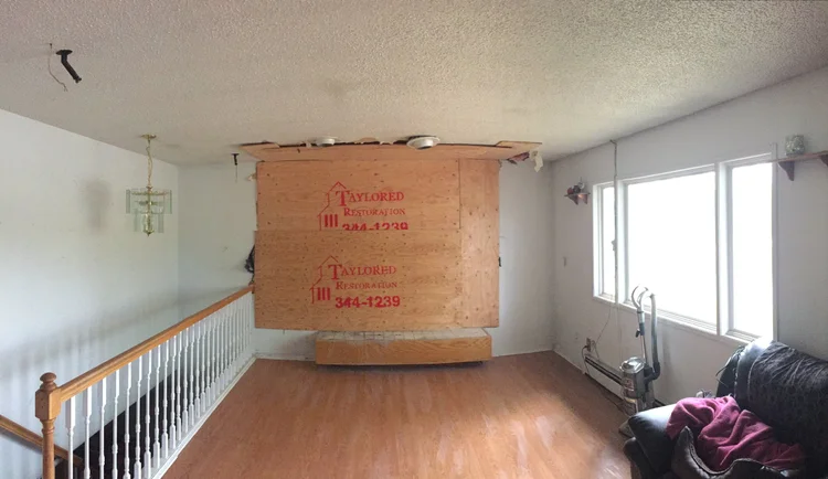 Room prepared for restoration with protective covering and flooring removed