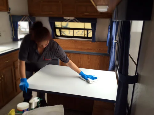 Technician cleaning and sanitizing surface during remediation process